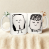 Set de dos tazas blancas con ilustraciones minimalistas de personajes adorables y frase complementaria “juntos es mejor”, ideal como regalo para pareja o amigos.